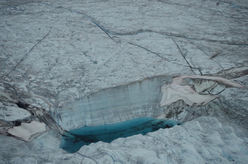 A moulin in a supraglacial lake on the Greenland Ice Sheet. © Mia Bennett, August 2014.